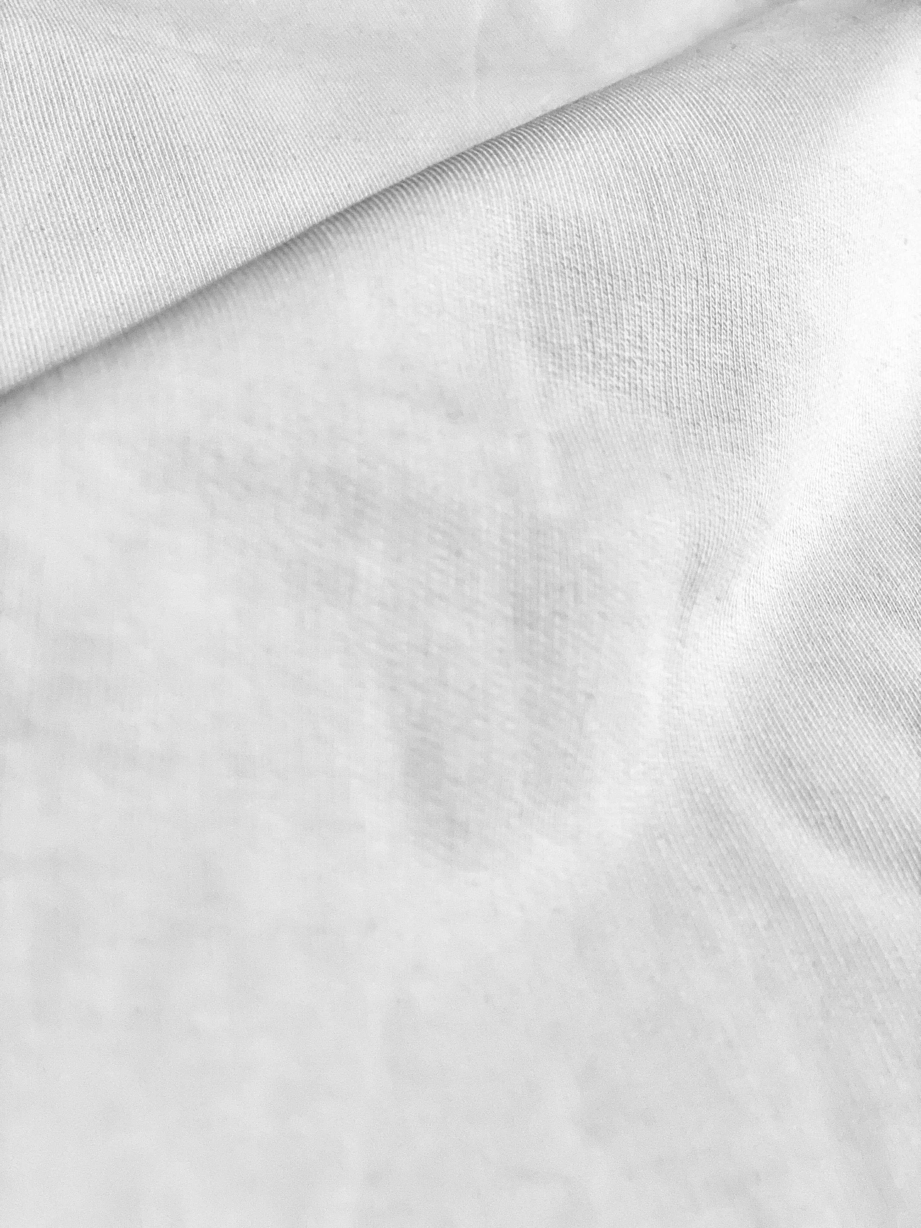 Close-up of premium white cotton streetwear fabric, Flex Your Vibe apparel texture