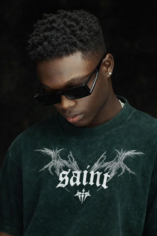 Model wearing Flex Your Vibe oversized gothic graphic tee with acid wash, dark sunglasses
