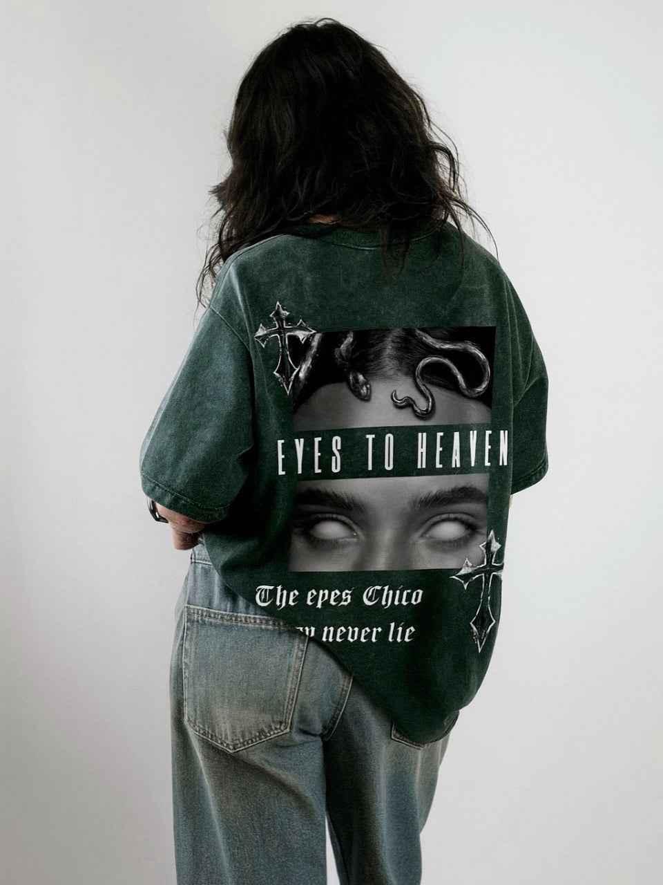 Person in oversized acid wash streetwear tee with gothic 'Eyes to Heaven' graphic design
