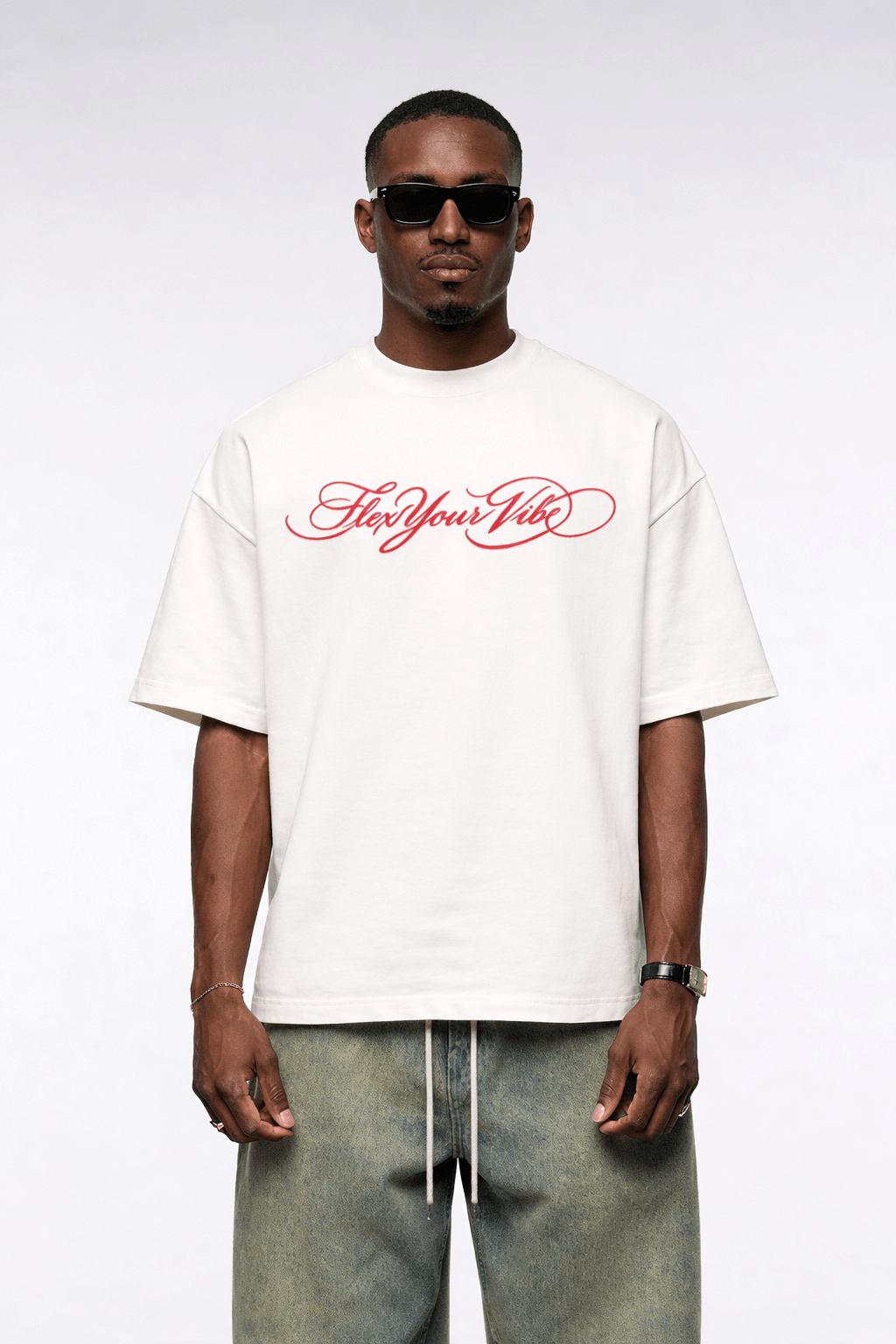 Man wearing a white t-shirt with red text and sunglasses on a white background