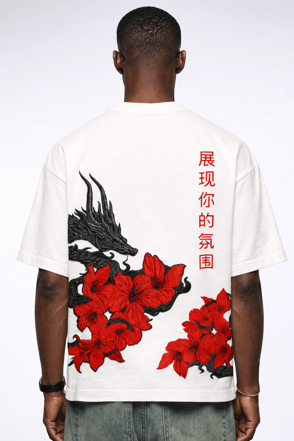 White t-shirt with red floral design and black dragon, on a white background