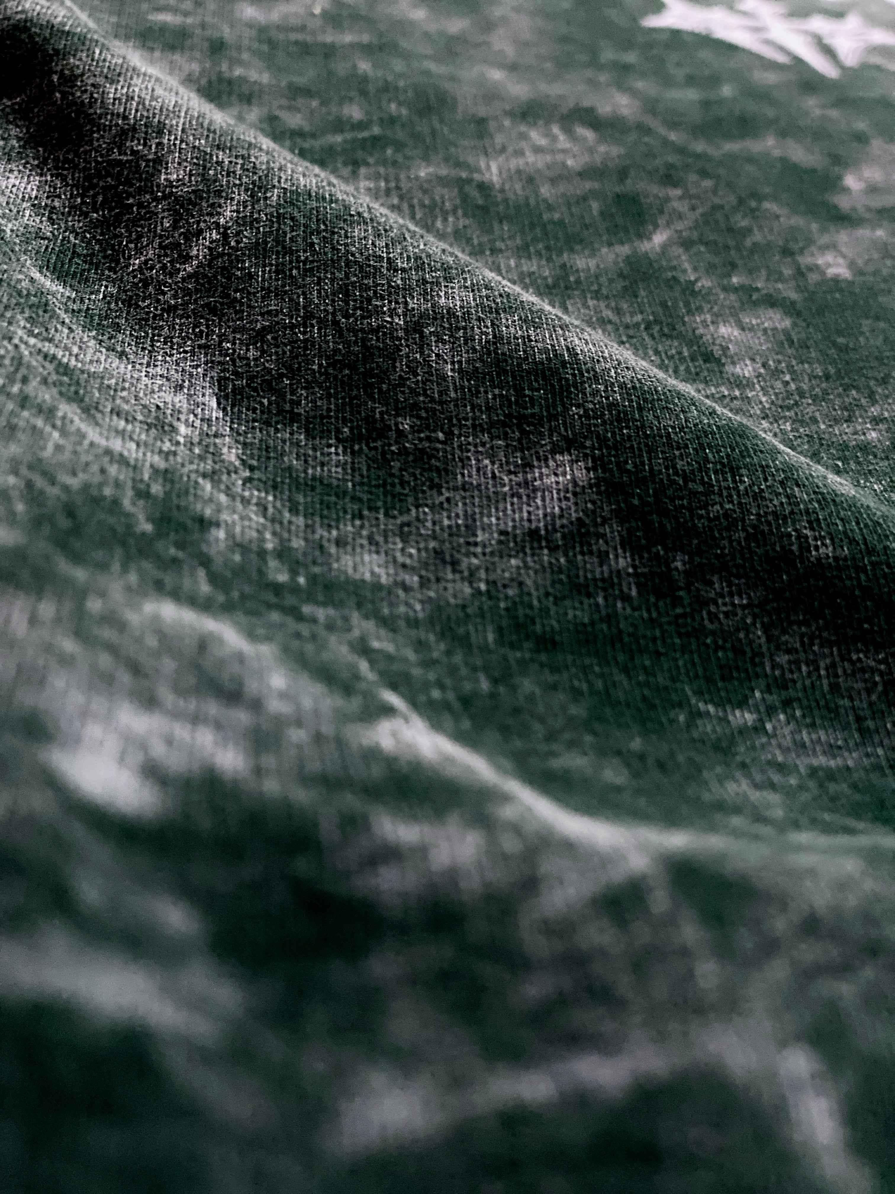 Close-up of green acid wash streetwear fabric texture, Flex Your Vibe premium apparel